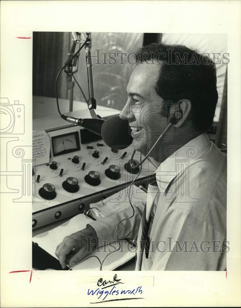 Carl Wigglesworth speaking on microphone at control desk-Historic Images