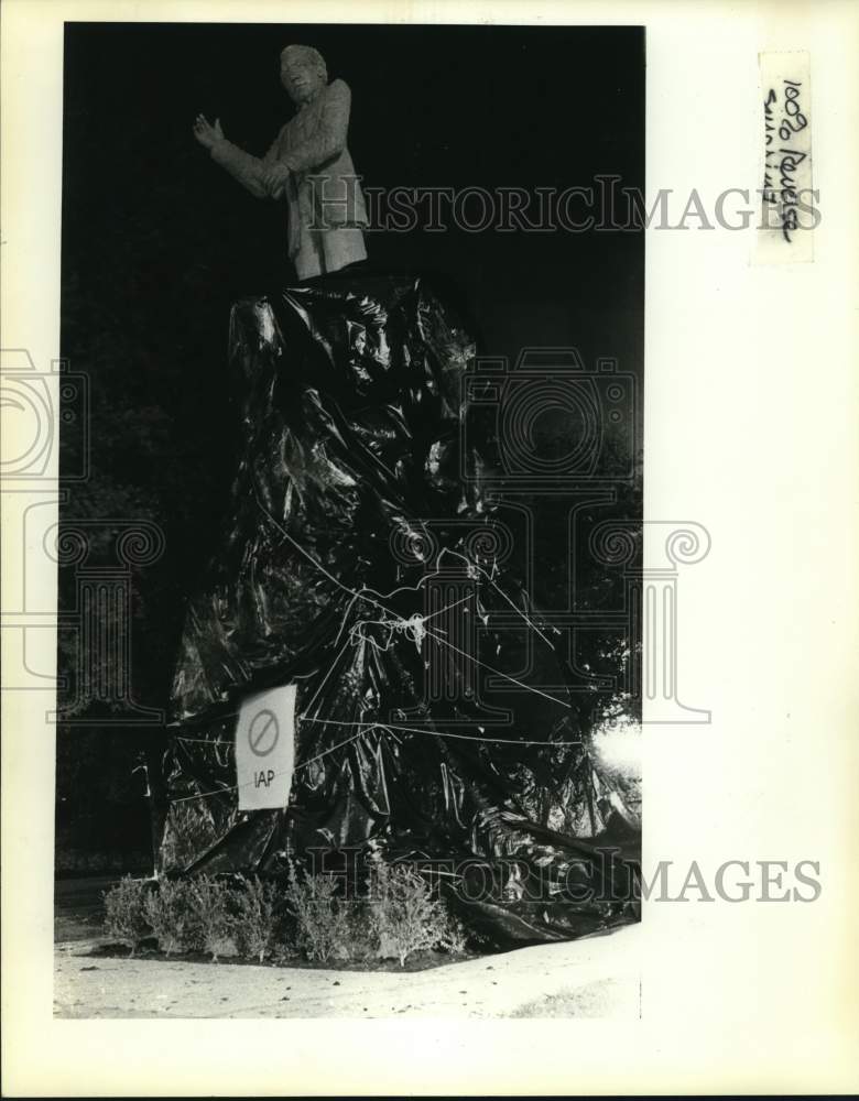 1982 Statue of Samuel Gomper wrapped in plastic, Texas-Historic Images