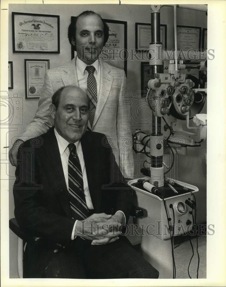 1983 Jose San Martin Jr. & Jose III with eye exam machine, Texas-Historic Images