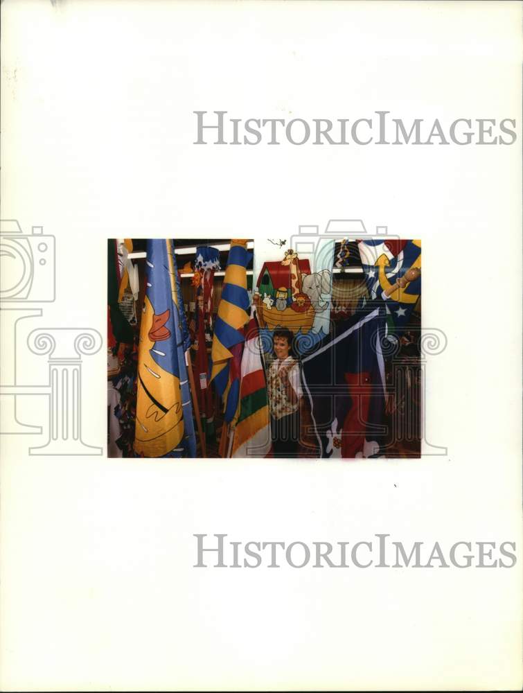 1995 Gerri Reynolds with decorative banners at the Flag Store-Historic Images