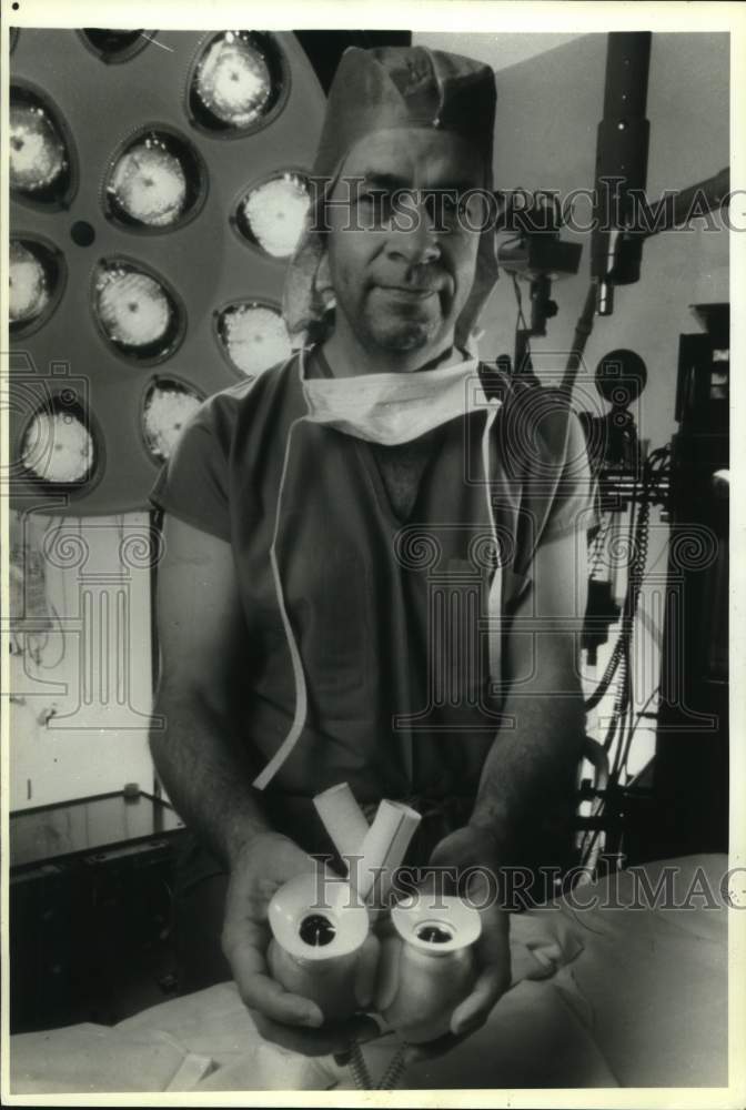 1989 Dr. Jack G. Copeland holding artificial heart, Arizona-Historic Images