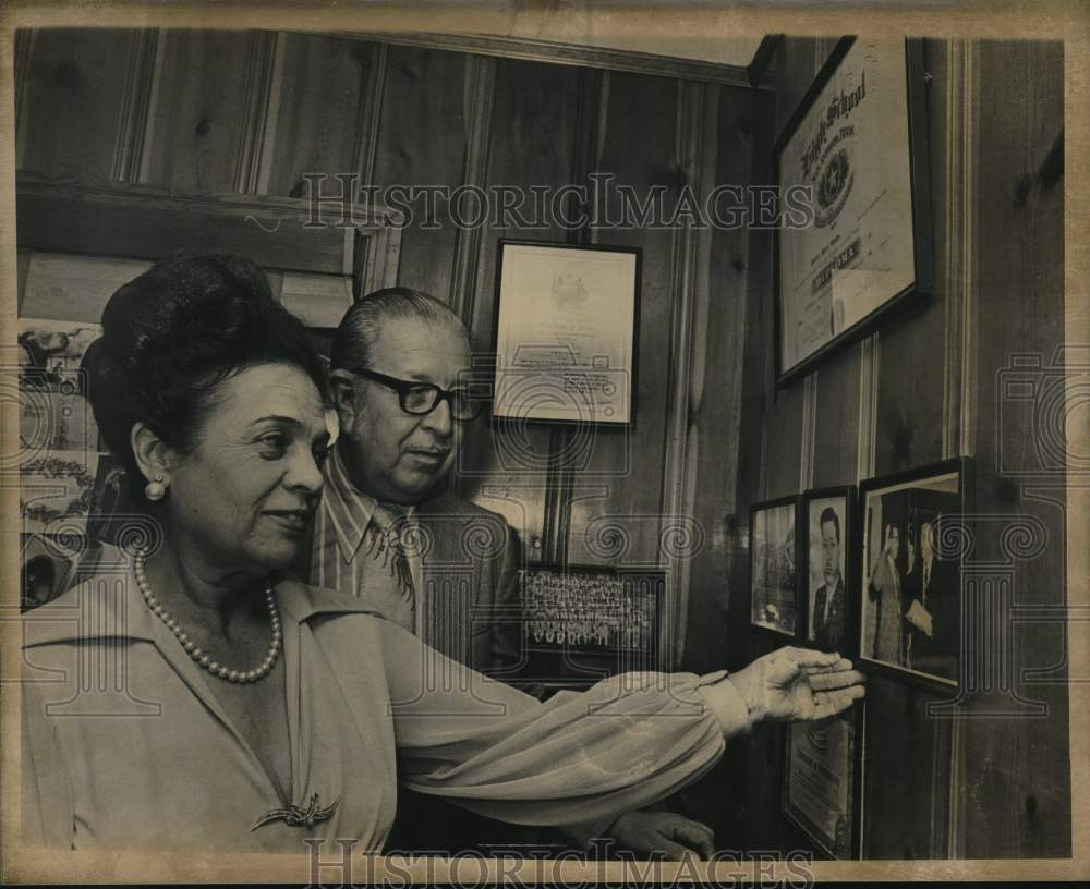 Lady and gentleman looking at pictures on wall-Historic Images