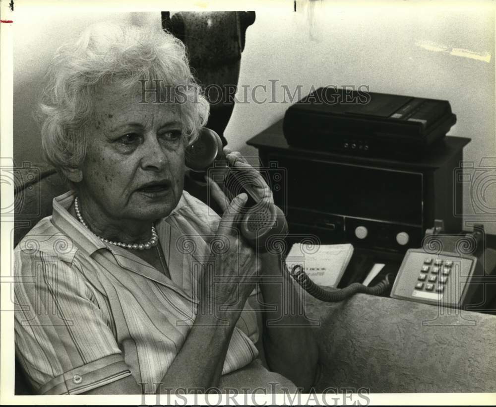 1983 Kathryn Toohey adjusting volume control on her phone, Texas-Historic Images