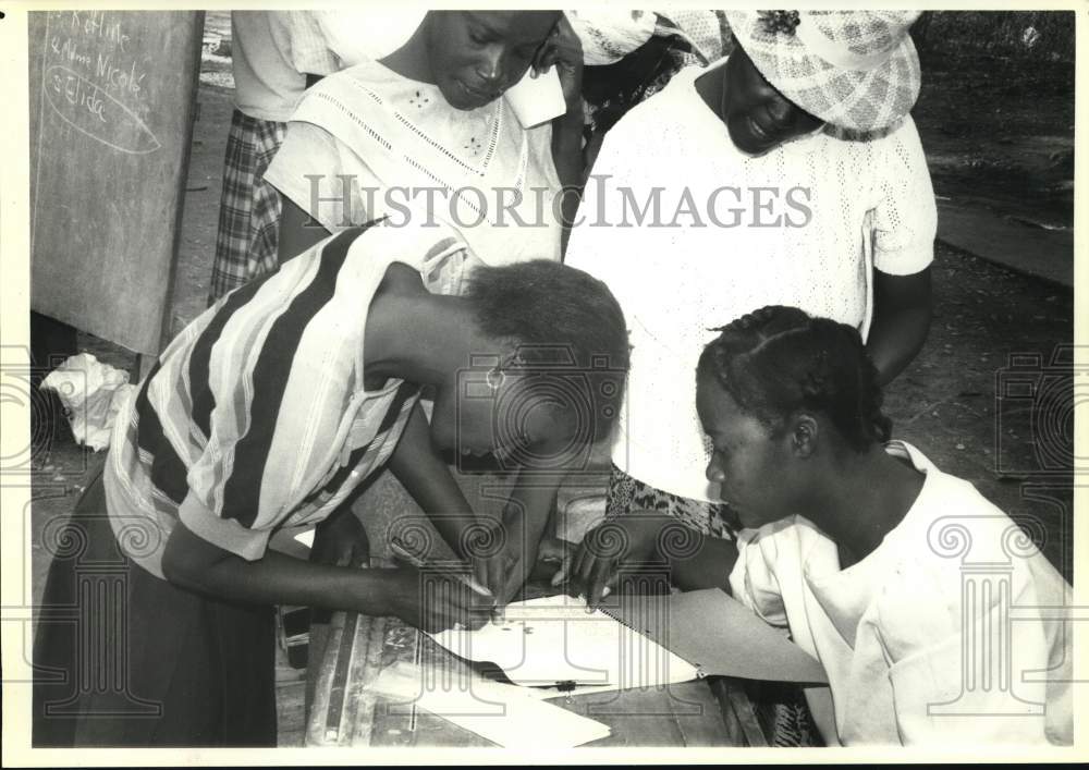 1990 Haiti Village Bank woman signs loan agreement.-Historic Images