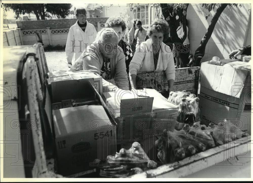 1991 Group of people unload truck of groceries in South Africa-Historic Images