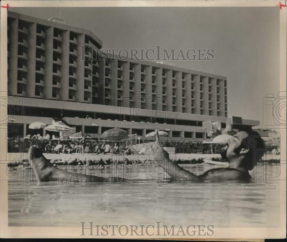 Gentleman reading newspaper while floating in the Dead Sea, Israel-Historic Images