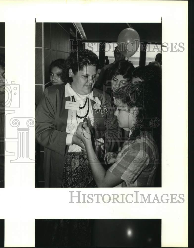 1988 Juanita Valdez showing her Golden Rule award to family, Texas-Historic Images
