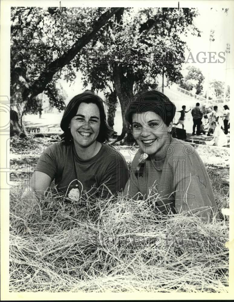 1988 &quot;Lark in the Park&quot; benefit co-chairs sitting on haystack, Texas-Historic Images