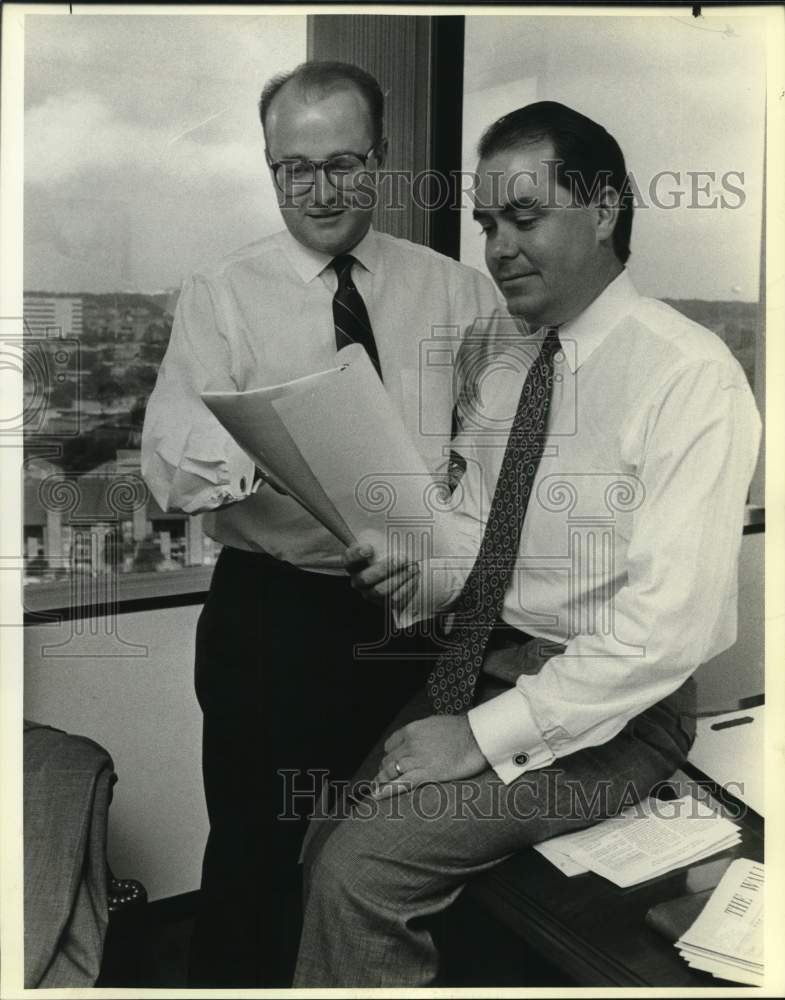 1990 Don L Merrill, Jr & Bob H. Hagan look at papers, San Antonio-Historic Images