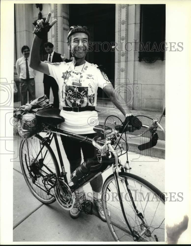 1992 Cyclist Jehova Villa Escamilla raises peace sign at Consulate-Historic Images