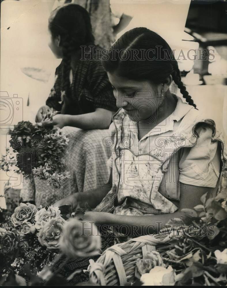 South American girl makes flower arrangements-Historic Images