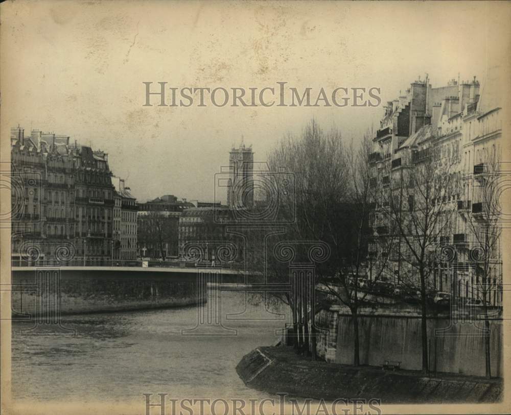 1975 Buildings tower over river in Paris, France-Historic Images