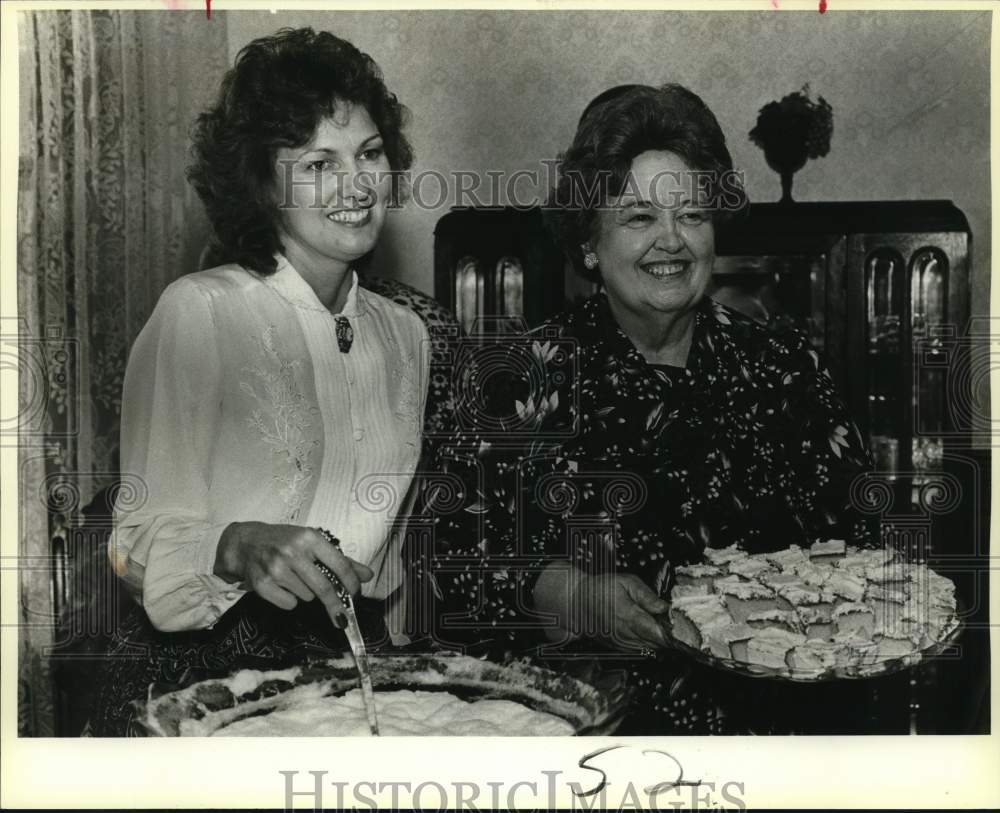 1986 Marcia Harmon and Katherine Poulis serve open house goodies.-Historic Images