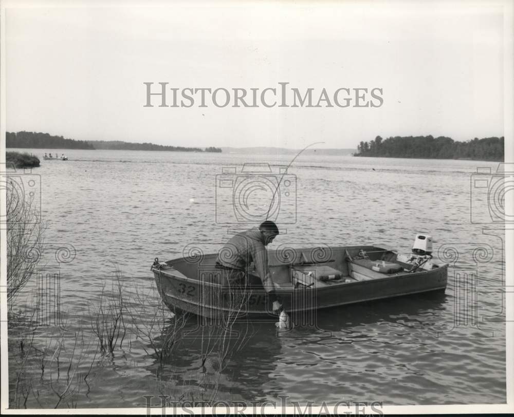 Angler pulls a fish from the water-fishing in the lakes of Kentucky.-Historic Images