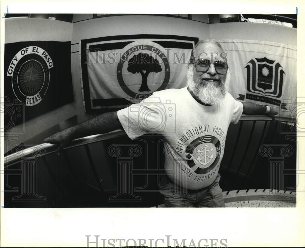 1992 Rich Kenny displays city flags in lobby of Emily Morgan Hotel-Historic Images