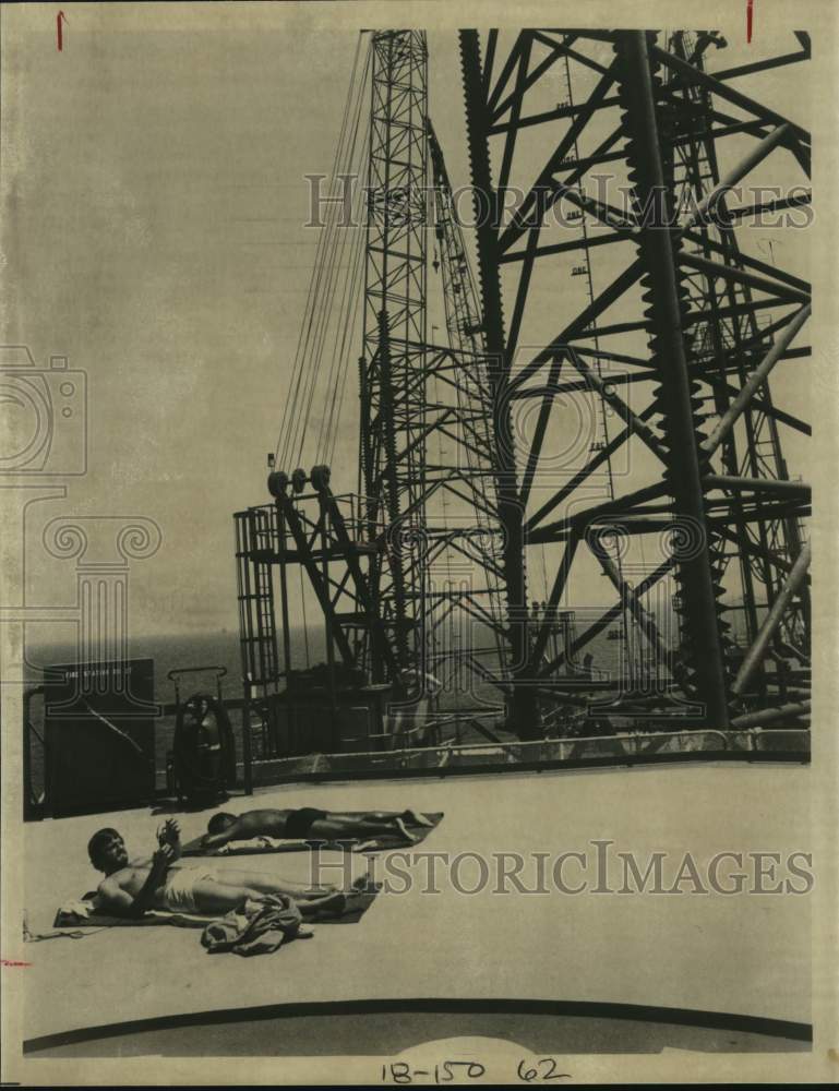 1981 Pennzoil Company oil drillers sunbathe on oil rig platform.-Historic Images