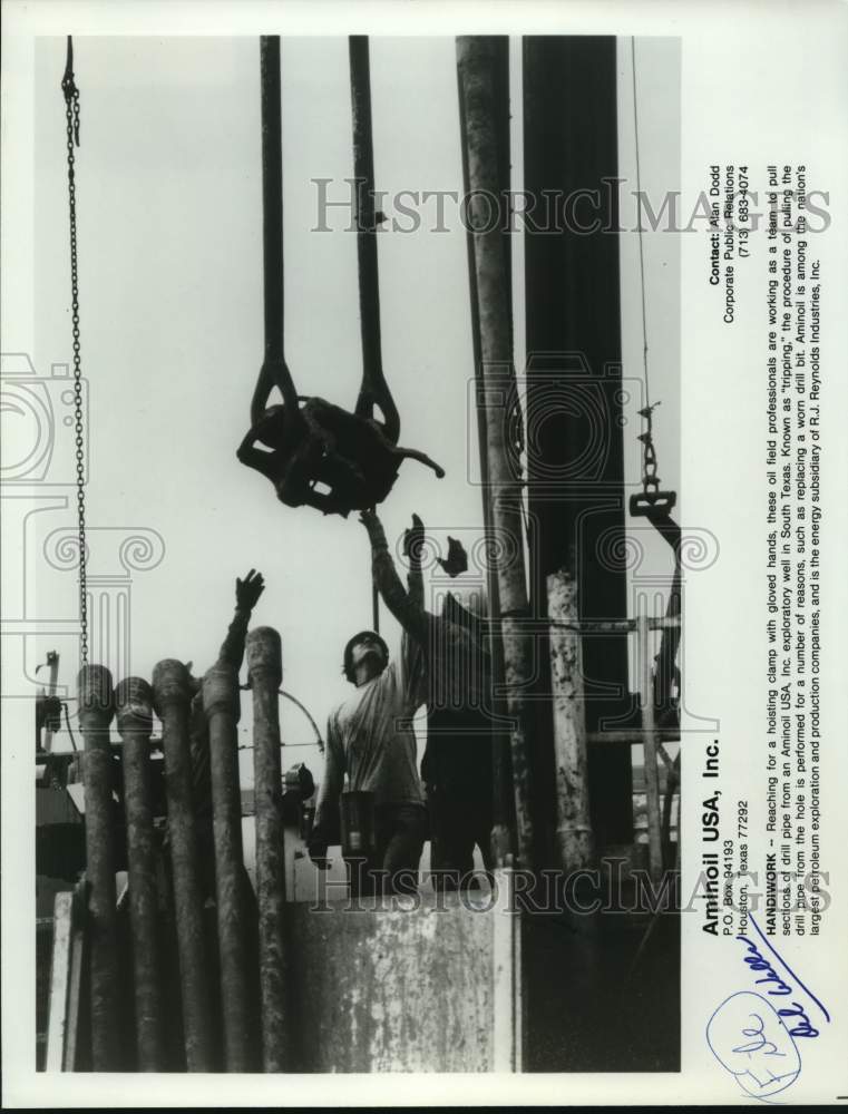 Workers pulling sections of drill pipe from exploratory well, Texas-Historic Images