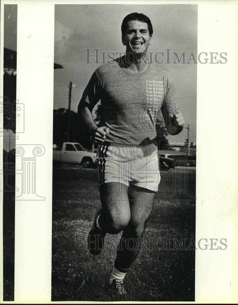 1985 Dr. Doug Adam Khoury running across field, Texas-Historic Images