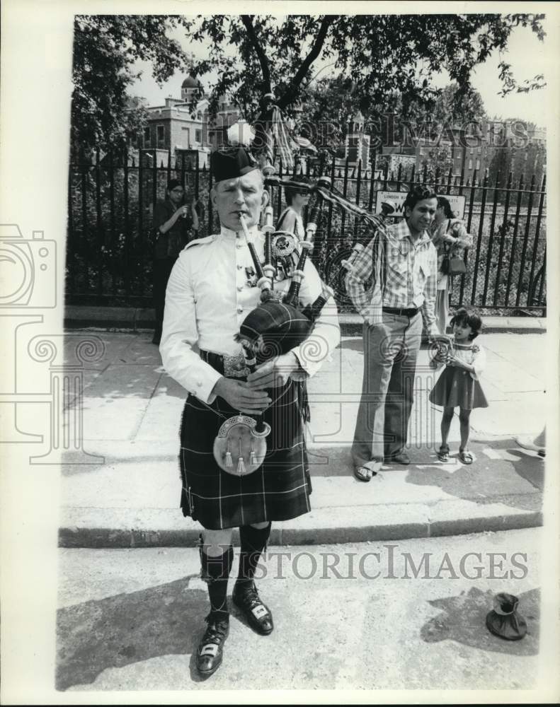 Tourist watch bagpiper in London.-Historic Images