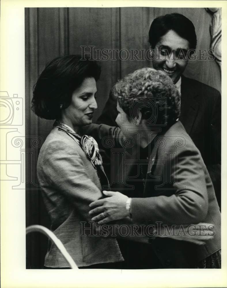 1986 Mrs. Drew Scobee hugs Mayor Cisneros' wife as Mayor watches-Historic Images