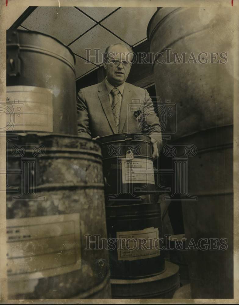 1979 Richard W. Vaughan, deputy County Clerk, with barrels-Historic Images