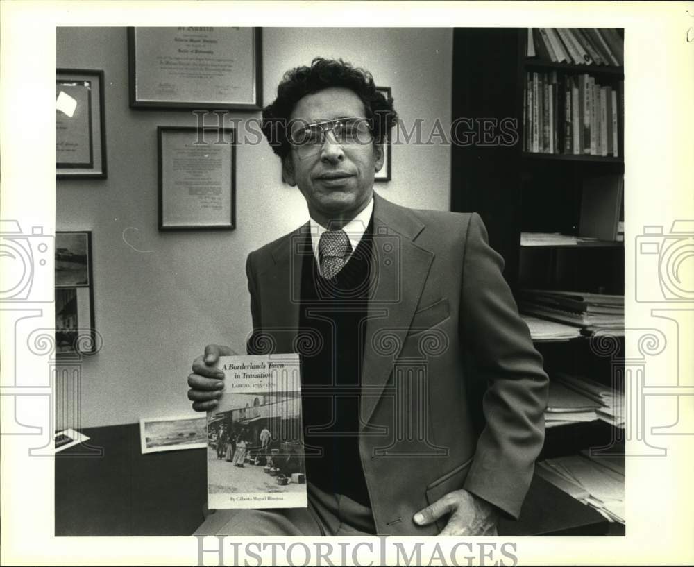 1984 Author Dr. Giliberto Hinojosa Poses With His Book , UTSA-Historic Images