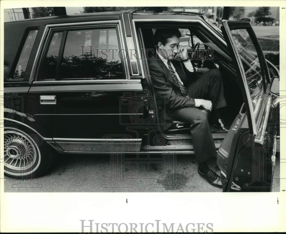 1989 Henry Cisneros talking on phone from his car, Texas-Historic Images