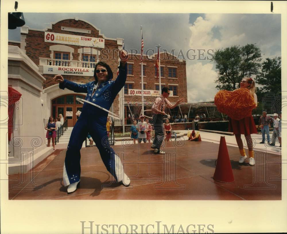 1992 "Elvis" performing in hula-hoop contest at Fiesta Texas, Texas-Historic Images