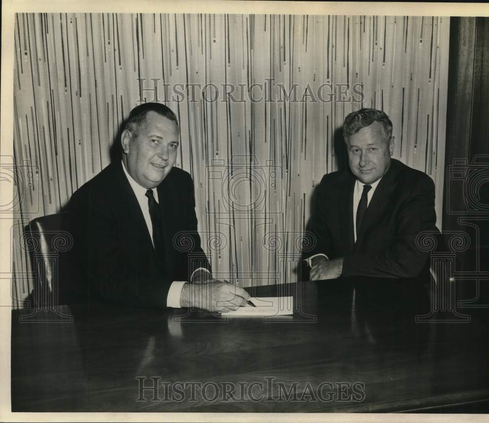 Volz signs paper with another man-Historic Images