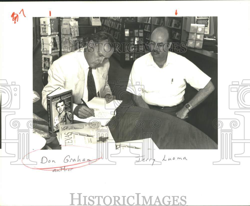 1989 Author Don Graham autographs book for Jerry Luoma.-Historic Images