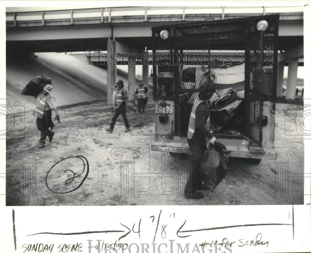 1990 Goodwill highway cleanup workers load trash bags into truck-Historic Images