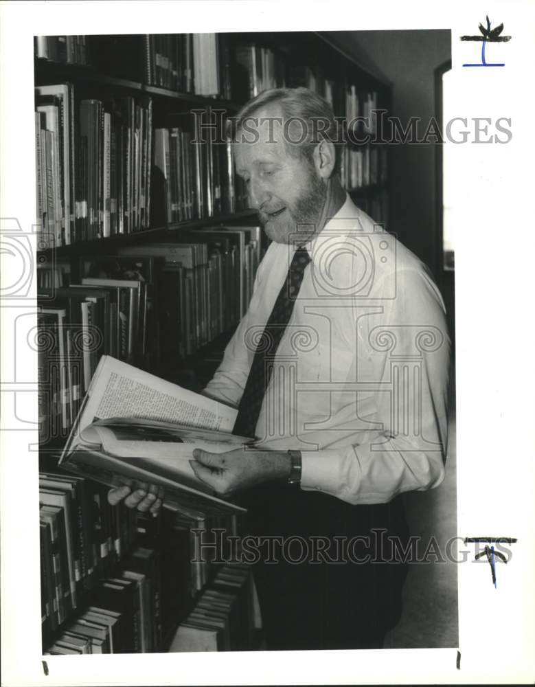 1990 Library Director David Leamon looks through library book.-Historic Images