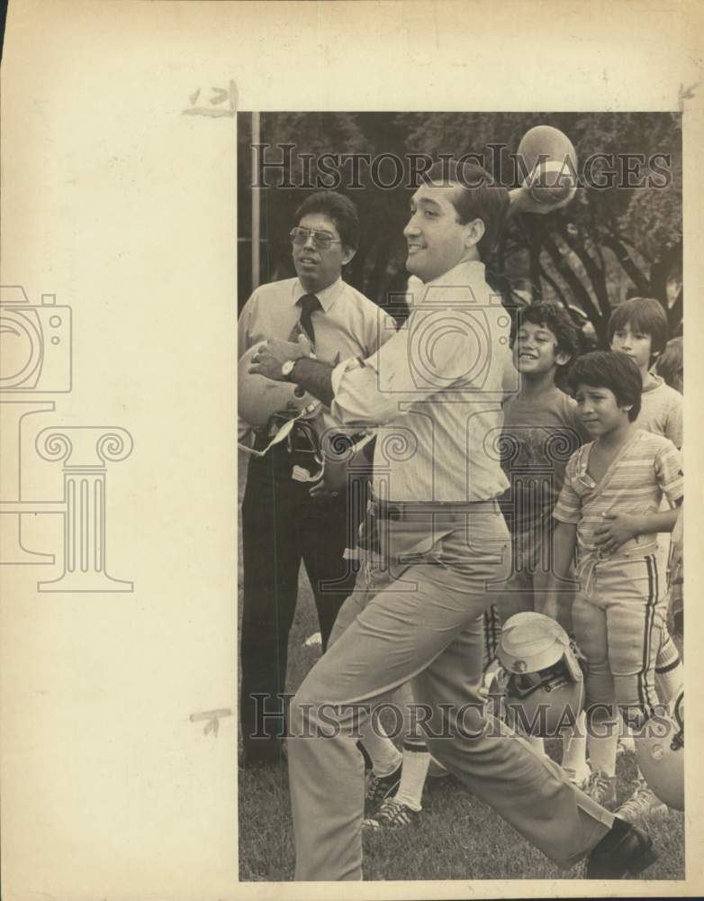 1981 Mayor Henry Cisneros plays with Pop Warner football players-Historic Images