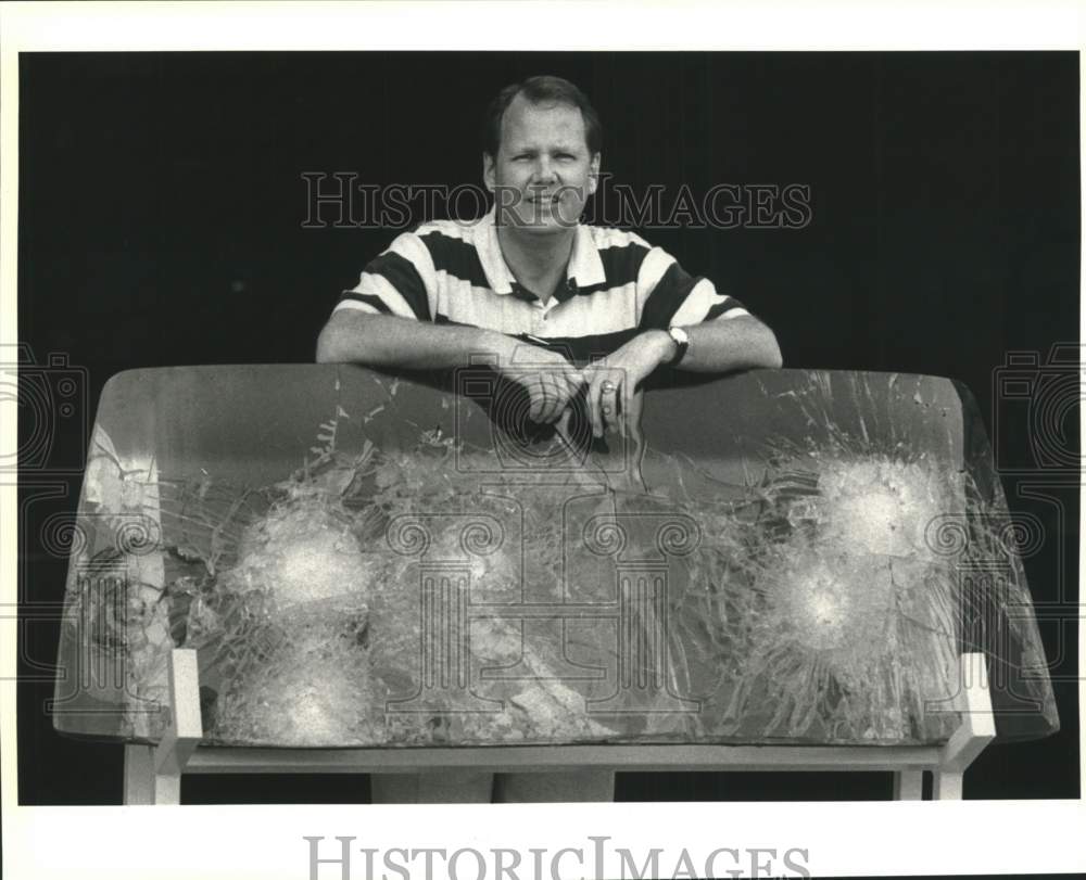 1992 Ronald Kimball rests against bullet proof windshield-Historic Images