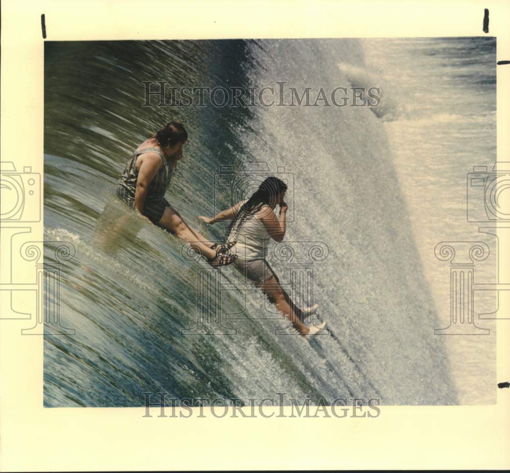 1992 Irma Gonzalez and Emma Davila slide down Espada Dam-Historic Images