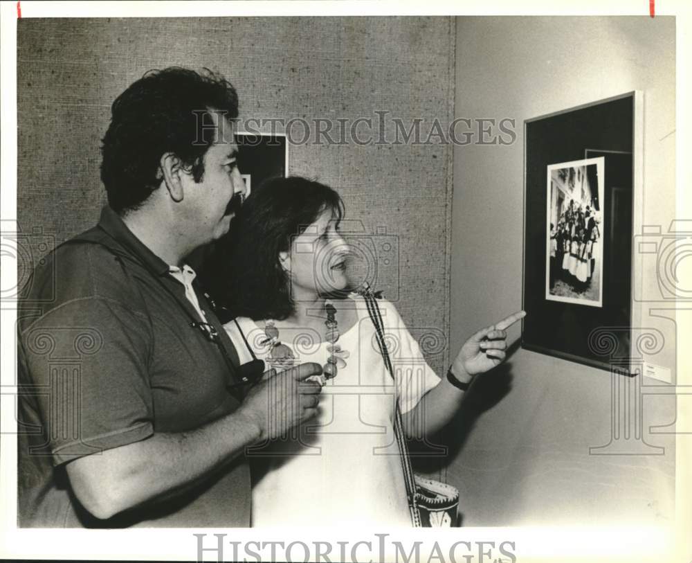 Jesse Herrera and wife view his work at Opening Reception Exhibit.-Historic Images