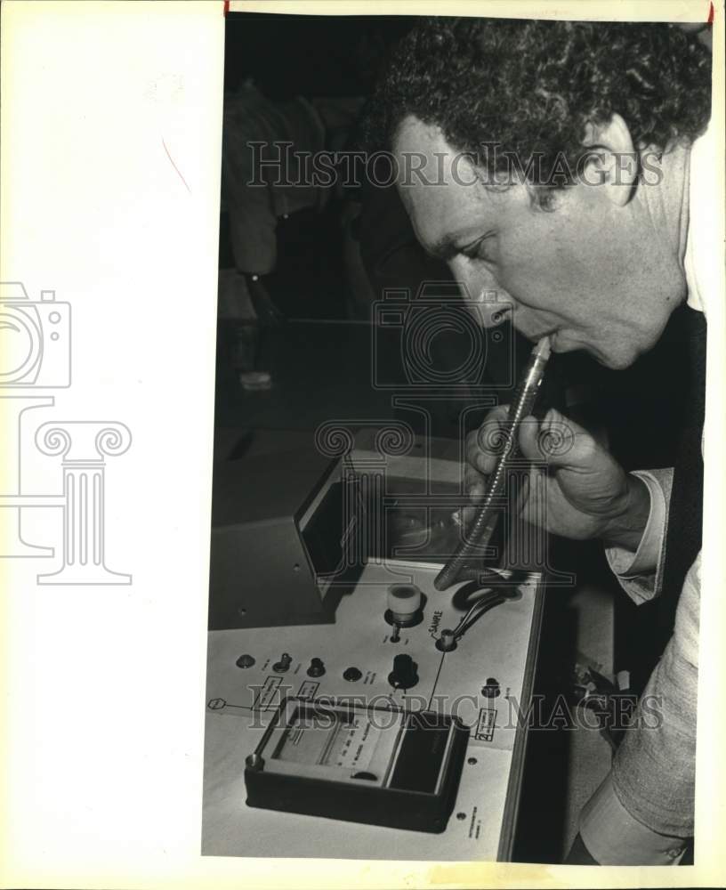 1983 Bob Krueger with breathalyzer at Margarita Mixer Party-Historic Images