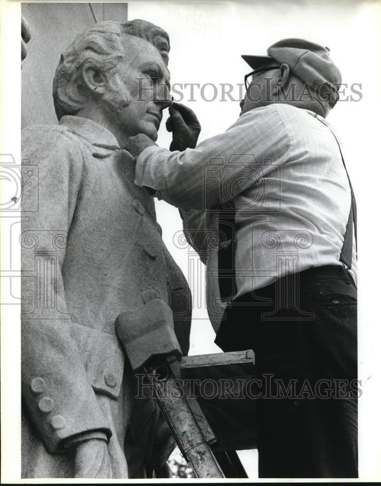 1988 Charles J. Long fixing nose of James Bowie statue, Texas-Historic Images