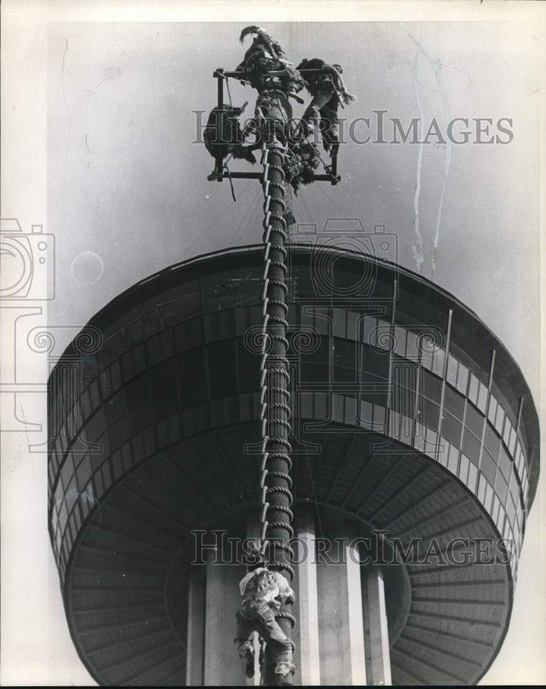 Workman climbs tower at Hemisfair.-Historic Images