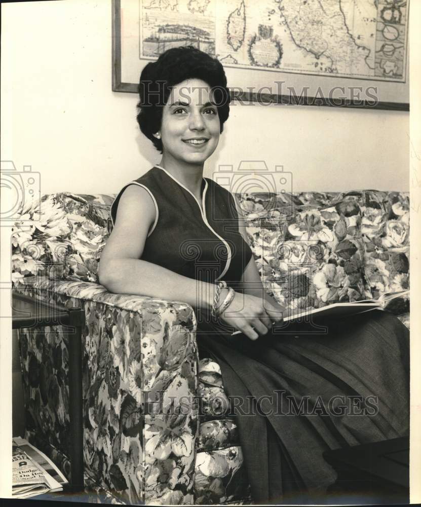 1960 Miss Rowena Maverick McNeel sits on couch looking through book.-Historic Images