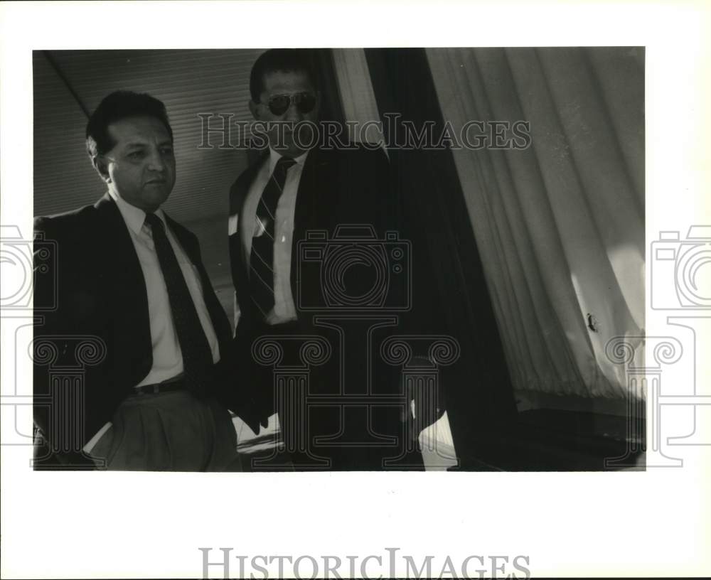 1993 Roger Lozano and Caesar Garcia examine building bullet holes.-Historic Images