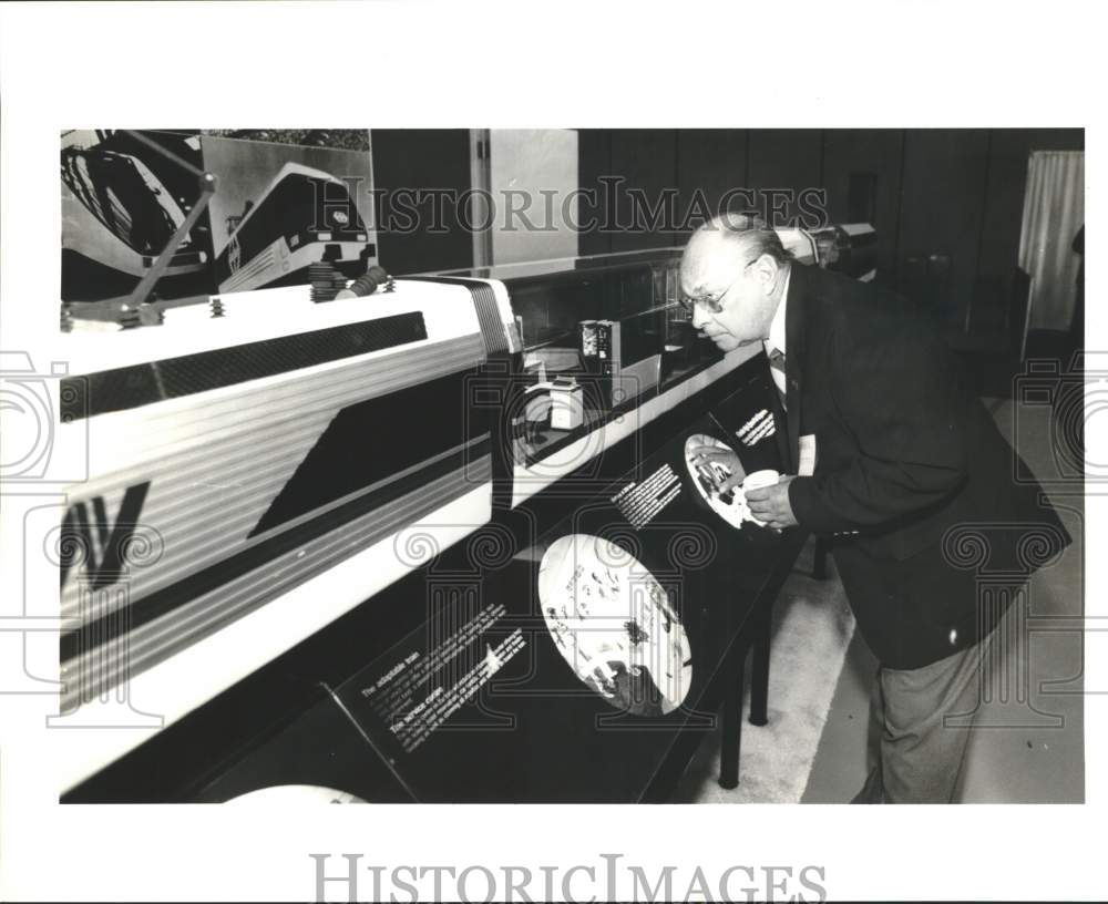 1990 Chuck McClellan with scale model of Florida FastTrain, Texas-Historic Images