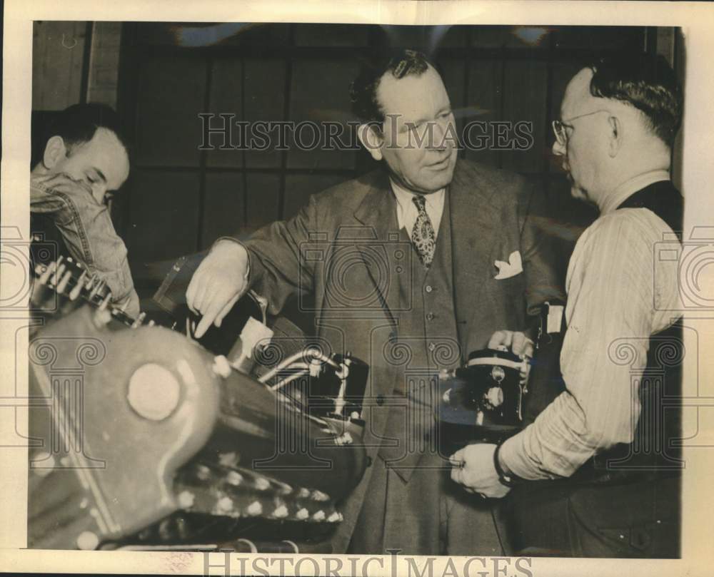 1943 Roy McPeak and James Wilkins discuss Packard engines.-Historic Images
