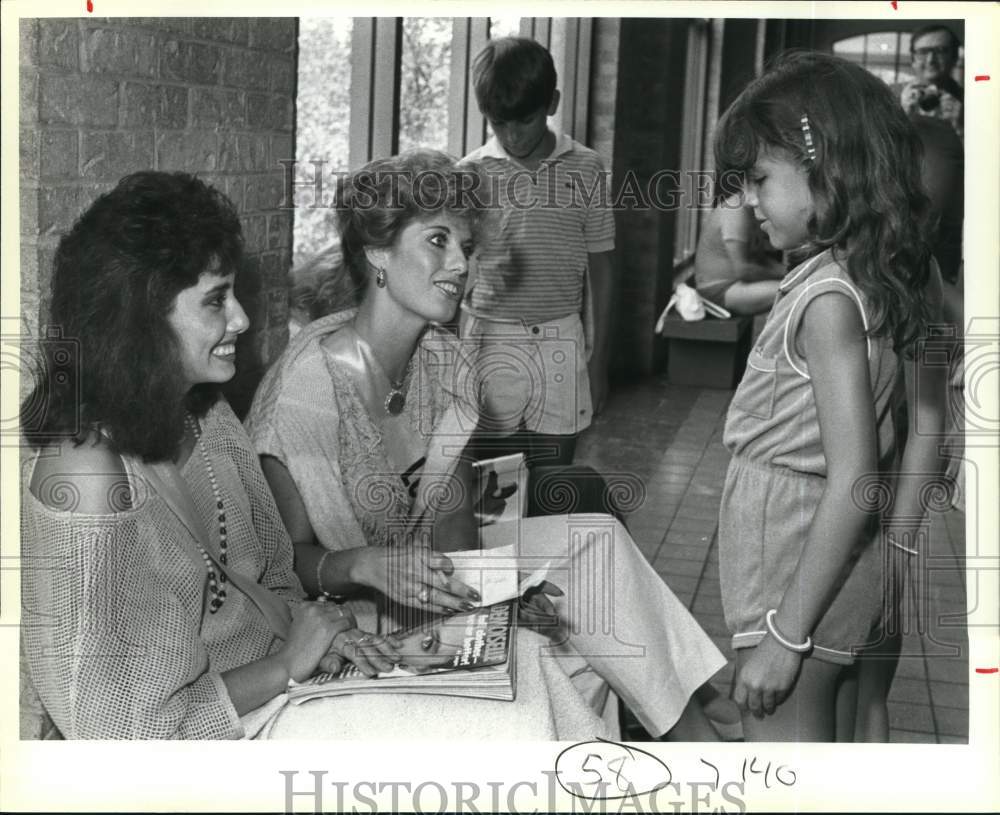 1984 Miss Texas USA contestants sign autographs for young girl-Historic Images