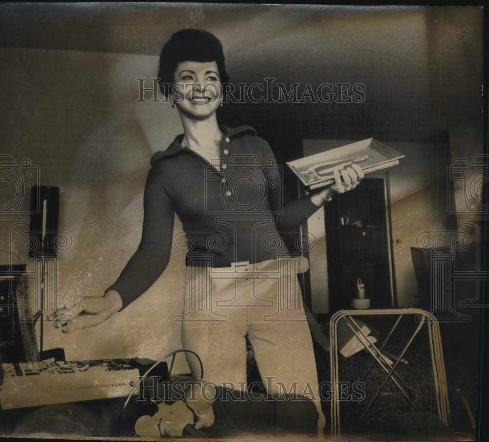 Smiling Woman Holds Frame, Turns On Lamp-Historic Images