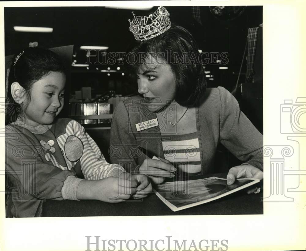 1985 Jonna Fitzgerald signs autograph for Lori Stewart, 5, Texas-Historic Images