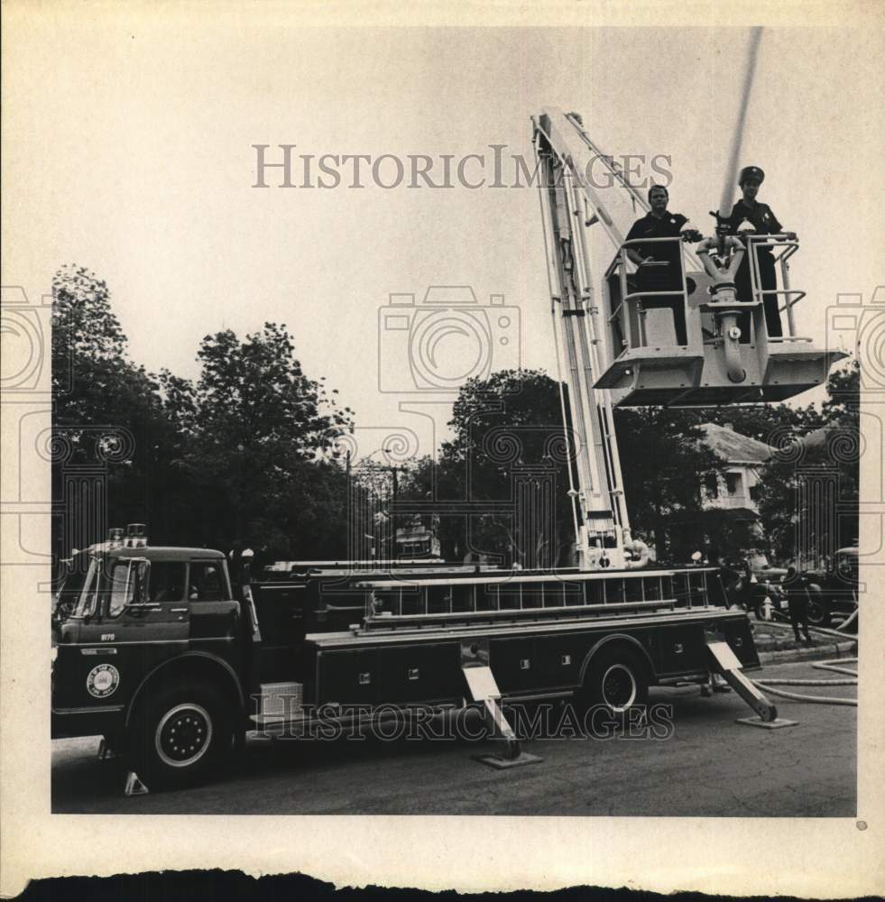 Press Photo Firefighters in bucket of ladder truck - saa64474- Historic Images