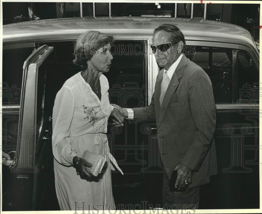 1985 Colonel Meredith Murphy helps Ann Murphy from car, Texas-Historic Images