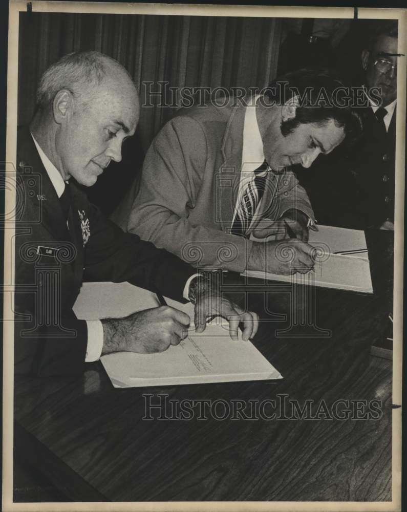Major General Lynwood E. Clark signs agreement with Kenneth Blaylock-Historic Images