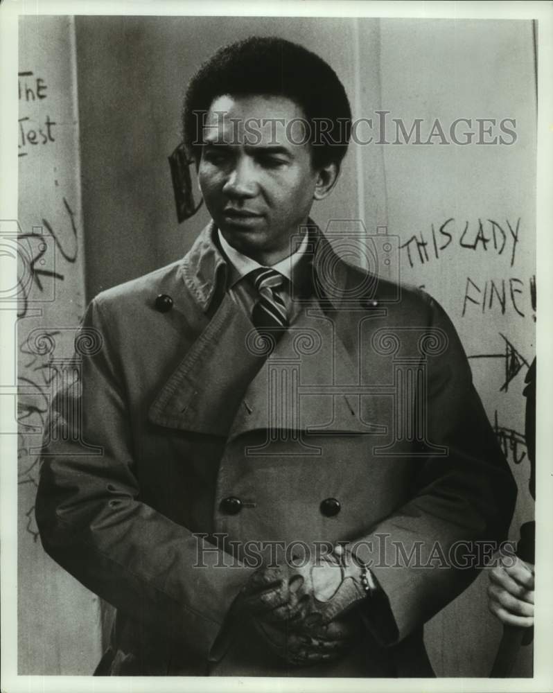 Actor Al Freeman, Jr. wearing trench coat in scene - Historic Images